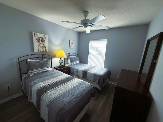 bedroom featuring ceiling fan, a textured ceiling, and dark hardwood / wood-style flooring