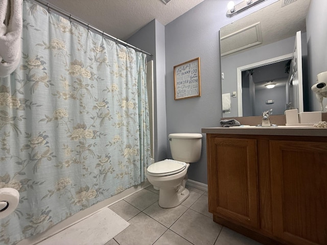 bathroom featuring tile patterned floors, toilet, a textured ceiling, and vanity