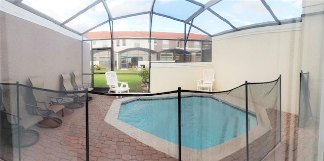 view of swimming pool featuring a lanai and a patio