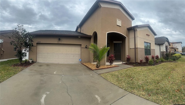 view of front of property with a garage and a front lawn