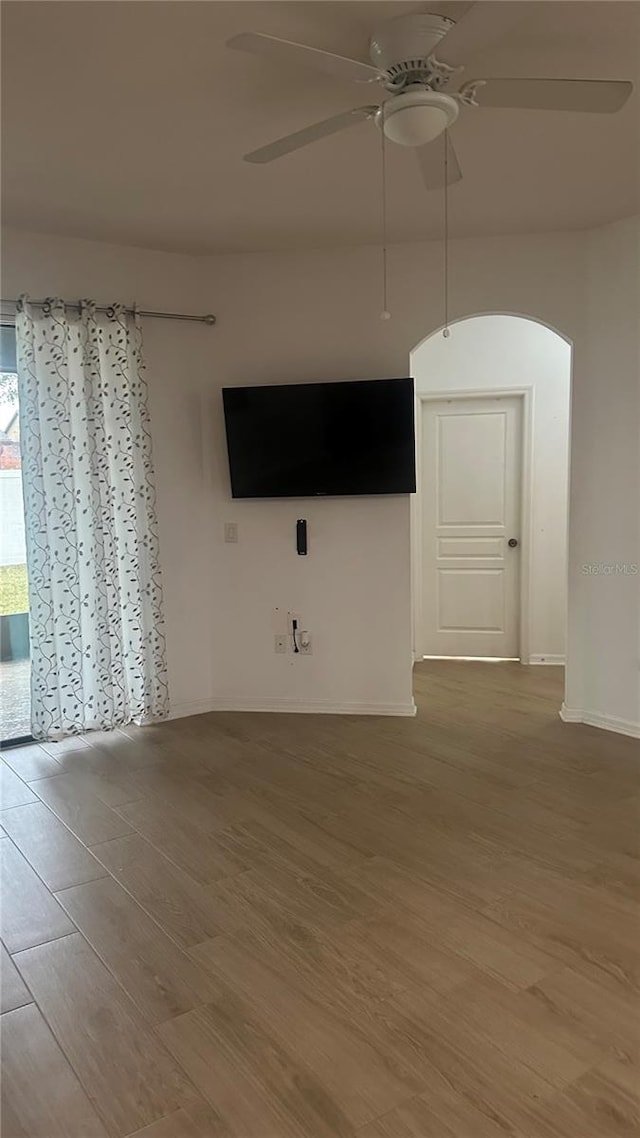 empty room featuring ceiling fan and wood-type flooring