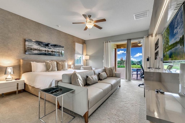 carpeted bedroom with ceiling fan and access to outside