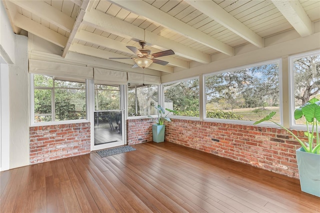 unfurnished sunroom featuring ceiling fan, beamed ceiling, and wooden ceiling