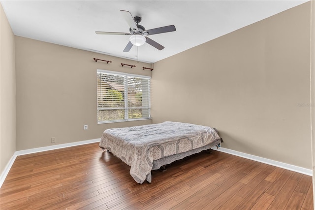 bedroom with ceiling fan and wood-type flooring