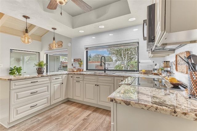 kitchen with sink, light hardwood / wood-style flooring, pendant lighting, vaulted ceiling with beams, and light stone counters