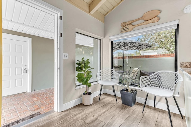 sunroom / solarium featuring wood ceiling and vaulted ceiling with beams