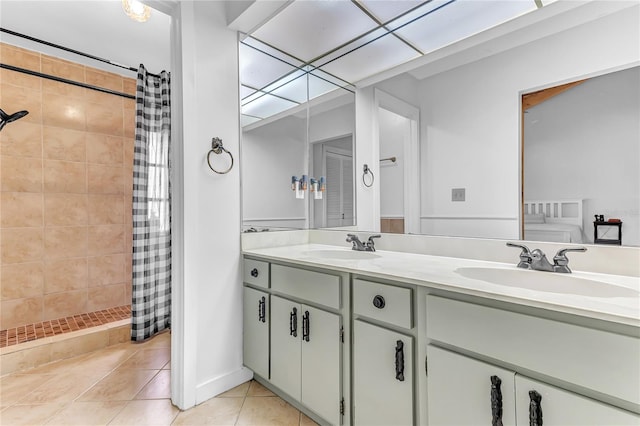 bathroom with tile patterned flooring, walk in shower, and vanity