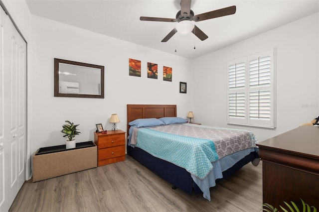 bedroom with a closet, ceiling fan, and light hardwood / wood-style floors