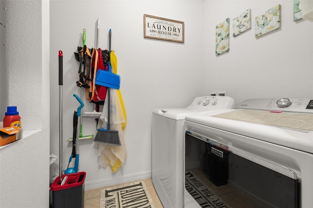 laundry room with tile patterned floors and washer and dryer