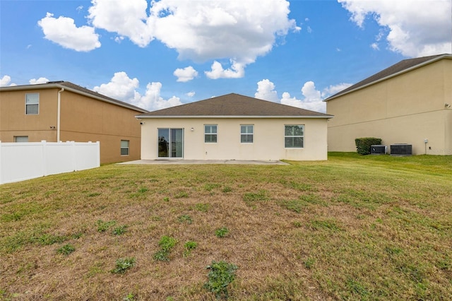 back of house featuring a patio area, central AC unit, and a yard