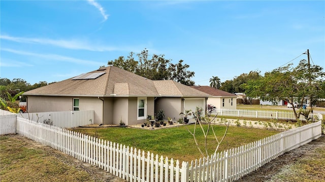 exterior space featuring a front yard and solar panels