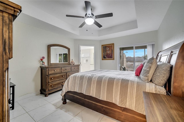 bedroom with ceiling fan, a raised ceiling, and access to outside