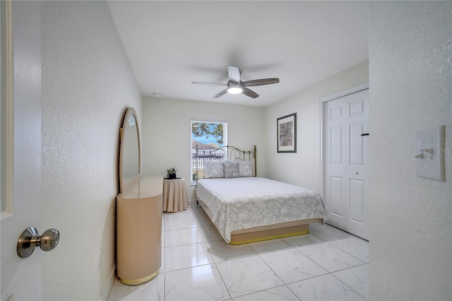 bedroom featuring ceiling fan and a closet