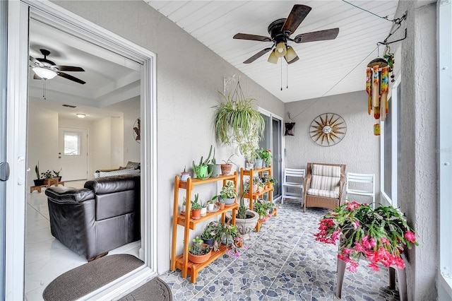 sunroom featuring ceiling fan