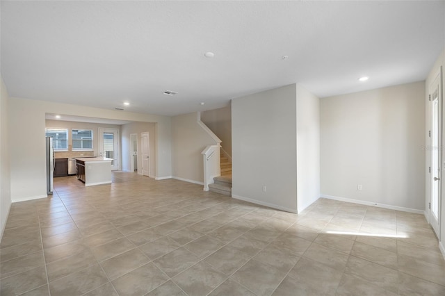 unfurnished living room featuring light tile patterned floors