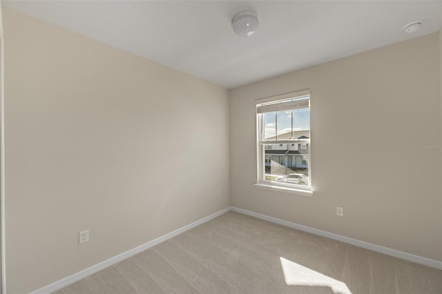 spare room with light colored carpet