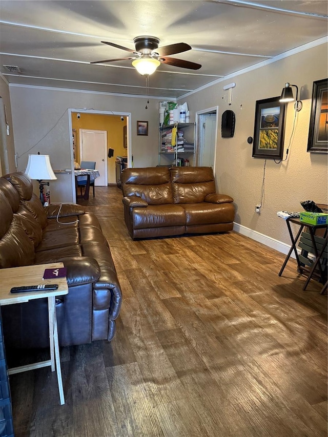 living room with crown molding, hardwood / wood-style floors, and ceiling fan