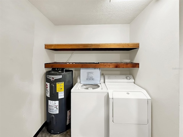 laundry area with washing machine and dryer, electric water heater, and a textured ceiling