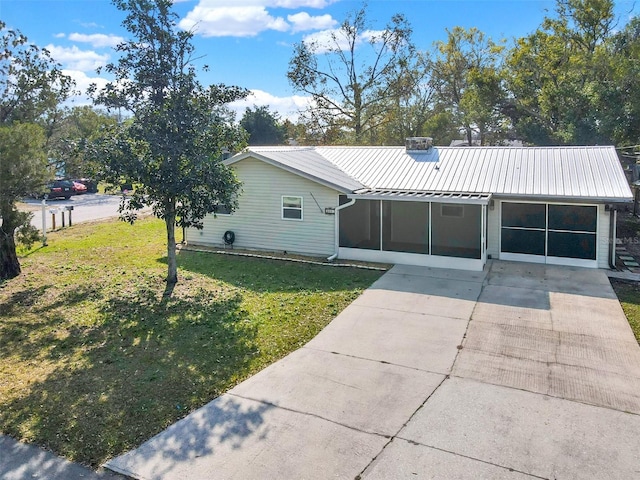 single story home featuring a sunroom and a front lawn