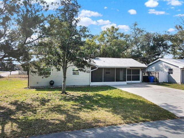 ranch-style home with a sunroom and a front lawn