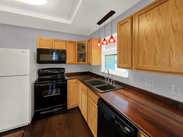 kitchen with pendant lighting, sink, wooden counters, dark hardwood / wood-style flooring, and black appliances