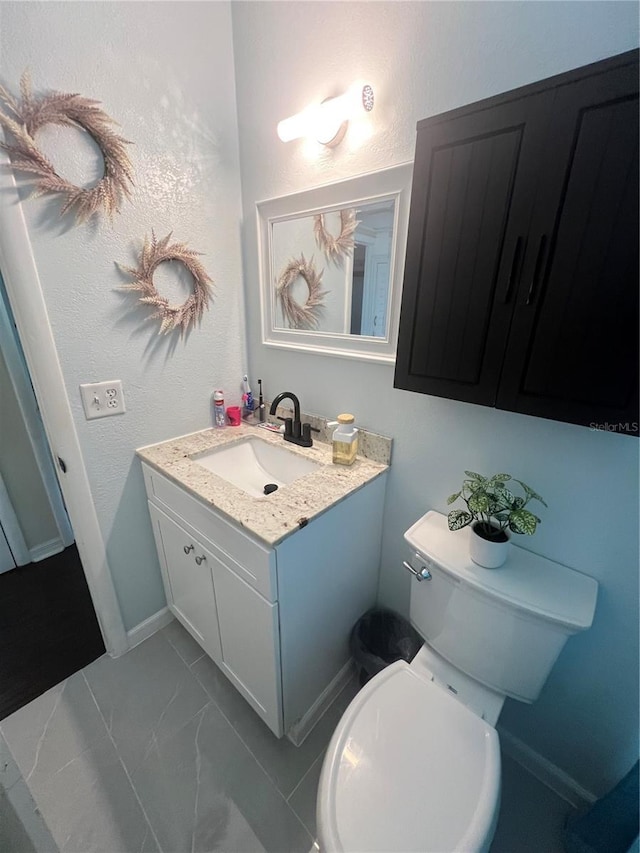 bathroom with toilet and vanity