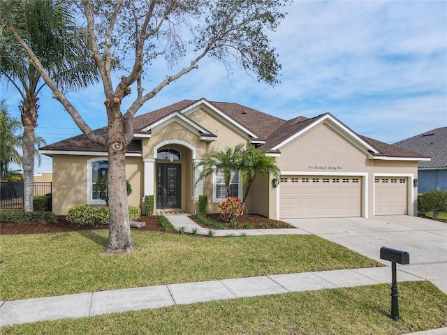 single story home featuring a garage and a front lawn