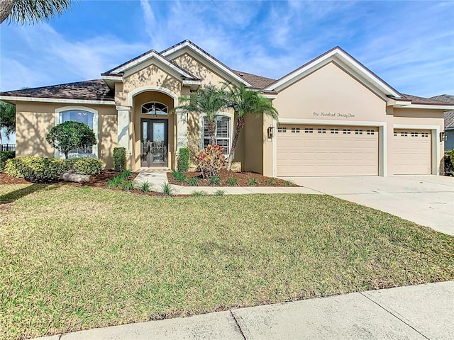 view of front of house featuring a front yard and a garage