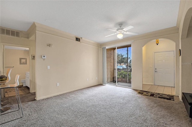 carpeted living room with ceiling fan