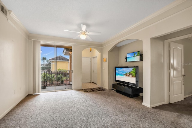 unfurnished living room with ceiling fan, carpet flooring, and ornamental molding