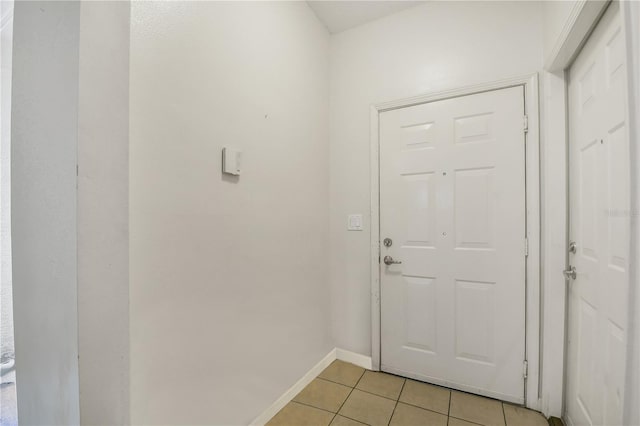 doorway to outside with light tile patterned floors