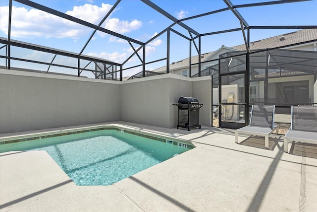 view of pool featuring grilling area, a lanai, and a patio