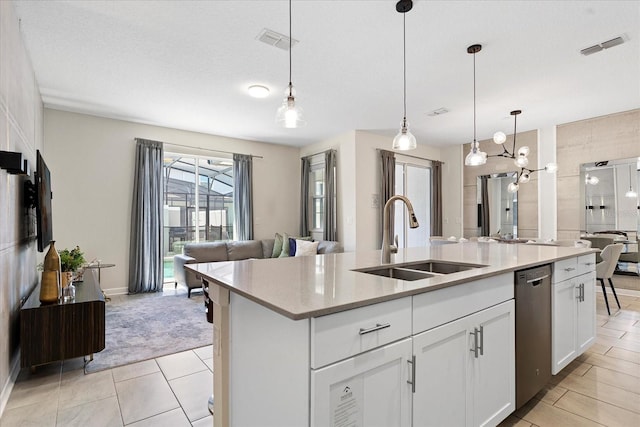 kitchen featuring sink, white cabinetry, decorative light fixtures, a center island with sink, and stainless steel dishwasher