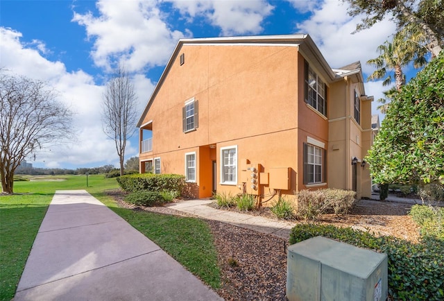 view of property exterior with a yard and stucco siding