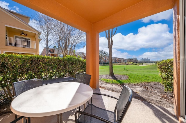 view of patio with outdoor dining area and ceiling fan