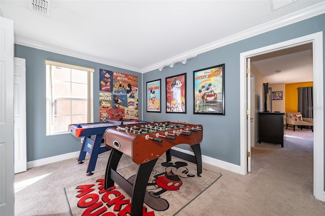 recreation room featuring baseboards, ornamental molding, visible vents, and light colored carpet