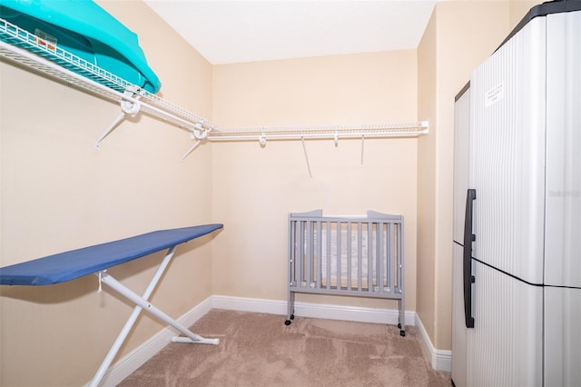 walk in closet with carpet floors