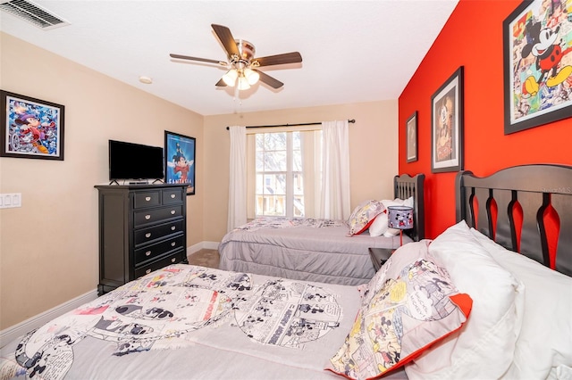 bedroom with a ceiling fan, visible vents, and baseboards