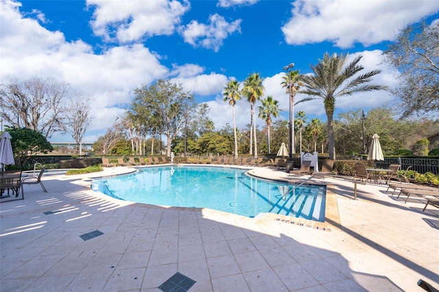 pool featuring fence and a patio