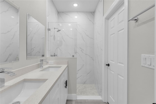 bathroom featuring a tile shower and vanity