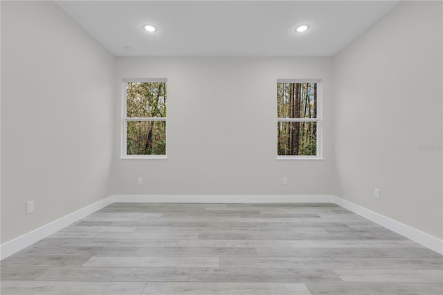 unfurnished room with plenty of natural light and light wood-type flooring