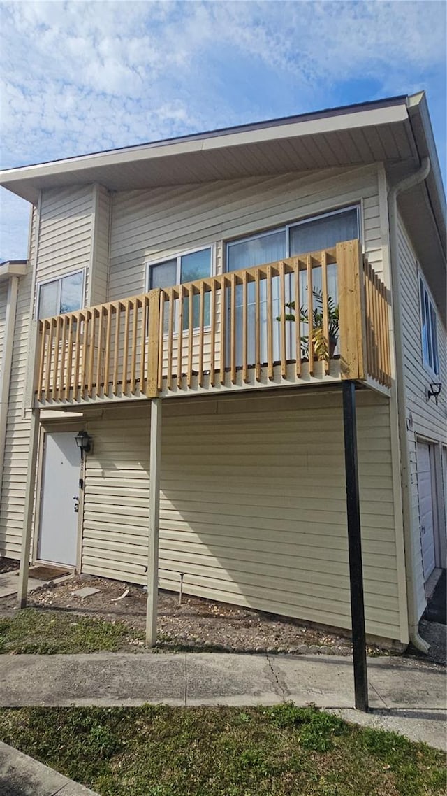 back of house featuring a garage and a balcony