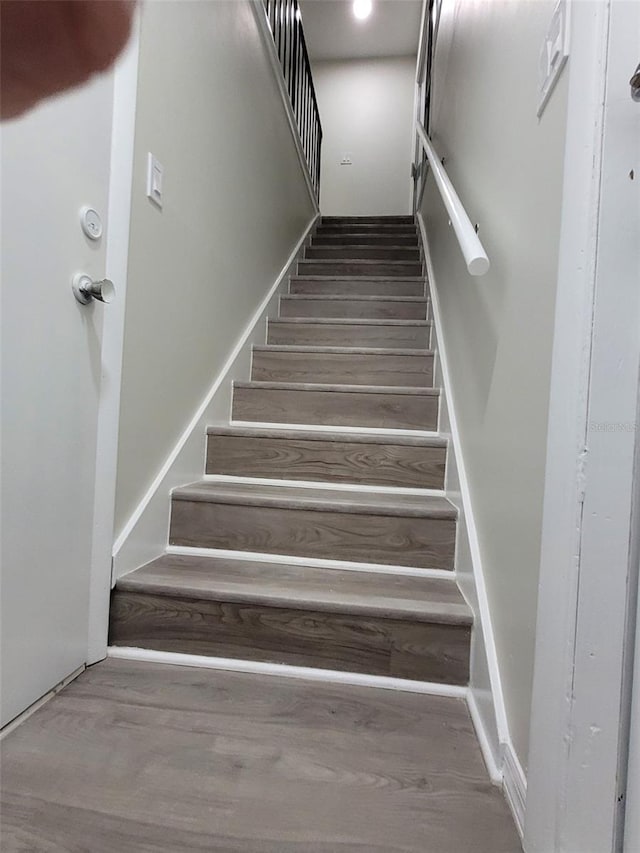 stairs featuring wood-type flooring