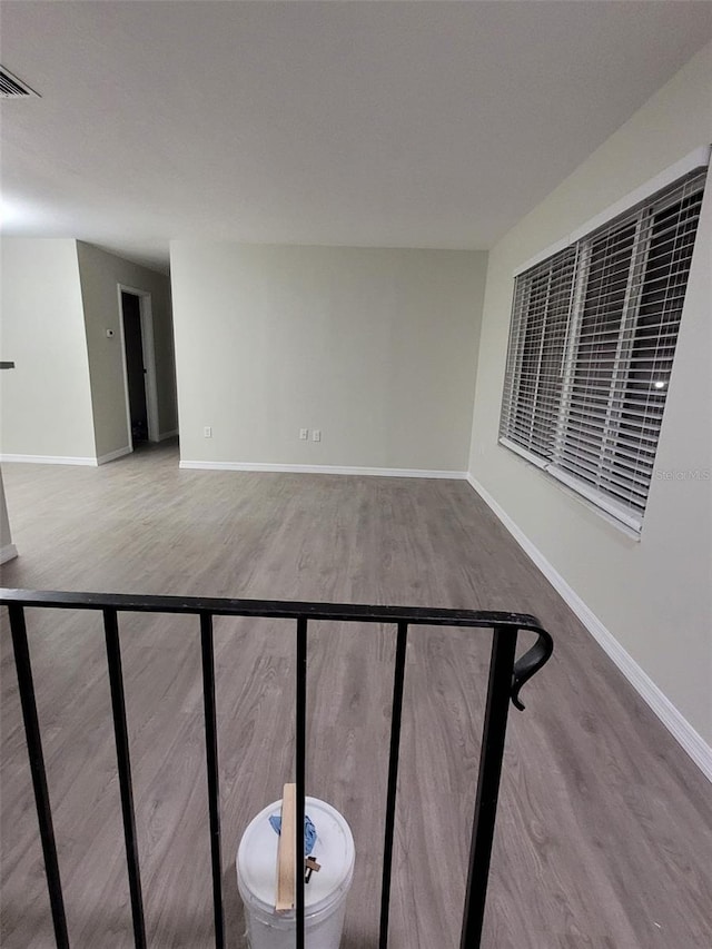 staircase with hardwood / wood-style flooring