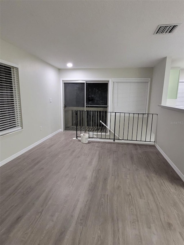 empty room with hardwood / wood-style floors