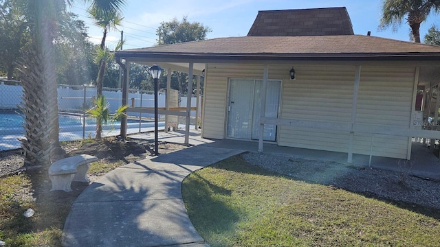 view of outbuilding with a fenced in pool and a lawn