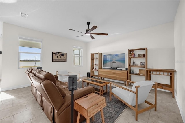 tiled living room with ceiling fan