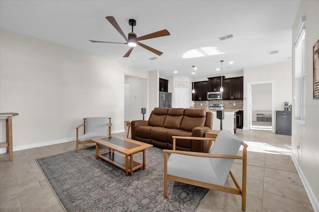 tiled living room with ceiling fan