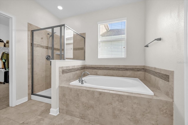 bathroom featuring tile patterned flooring and shower with separate bathtub