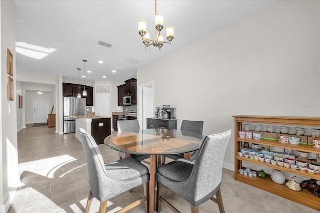 dining area featuring a chandelier and light tile patterned floors